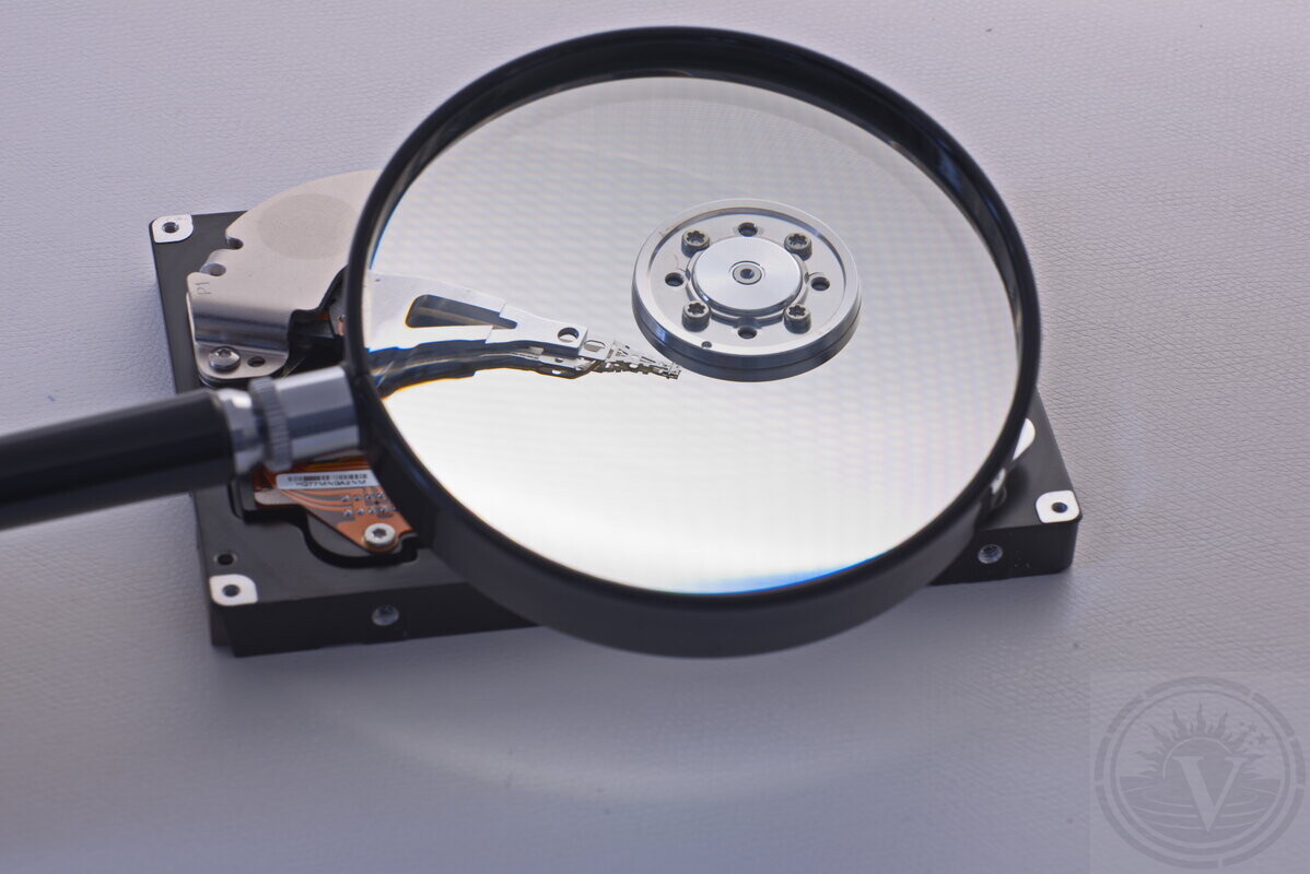 Data recovery specialist handling a hard drive in our laboratory