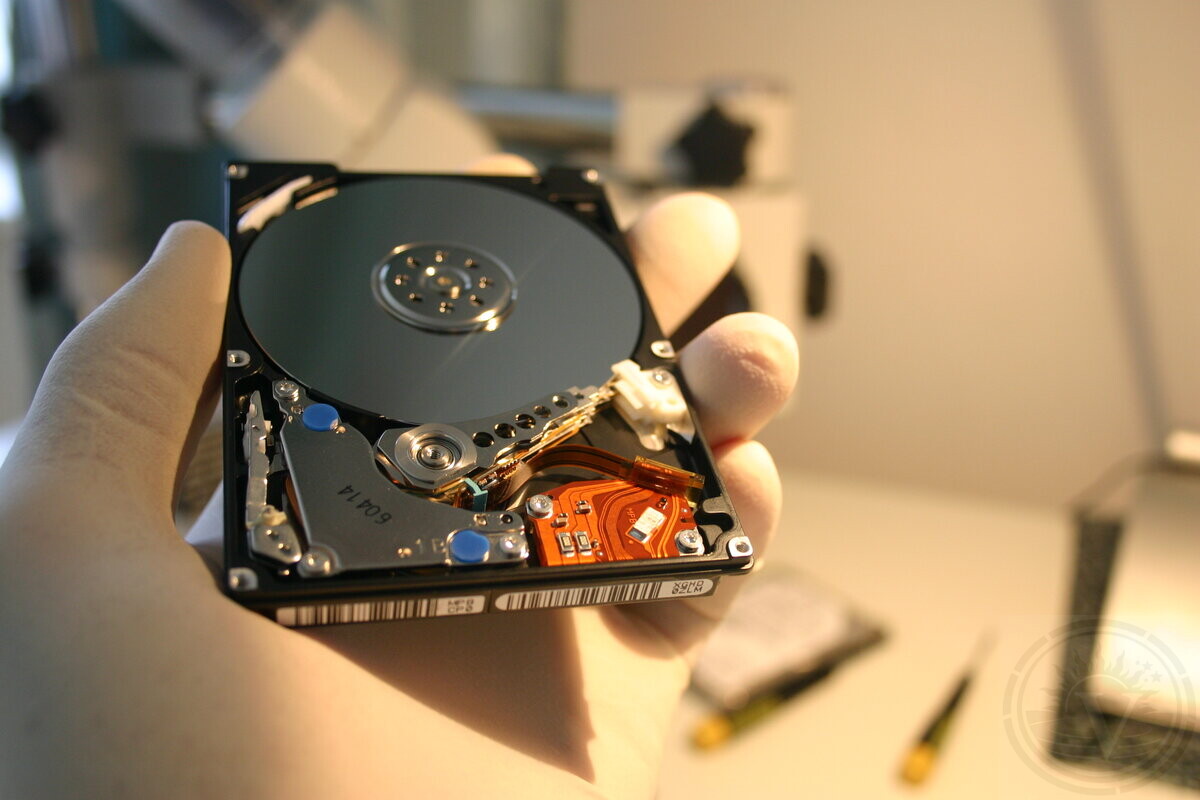 Data recovery specialist handling a hard drive in our laboratory