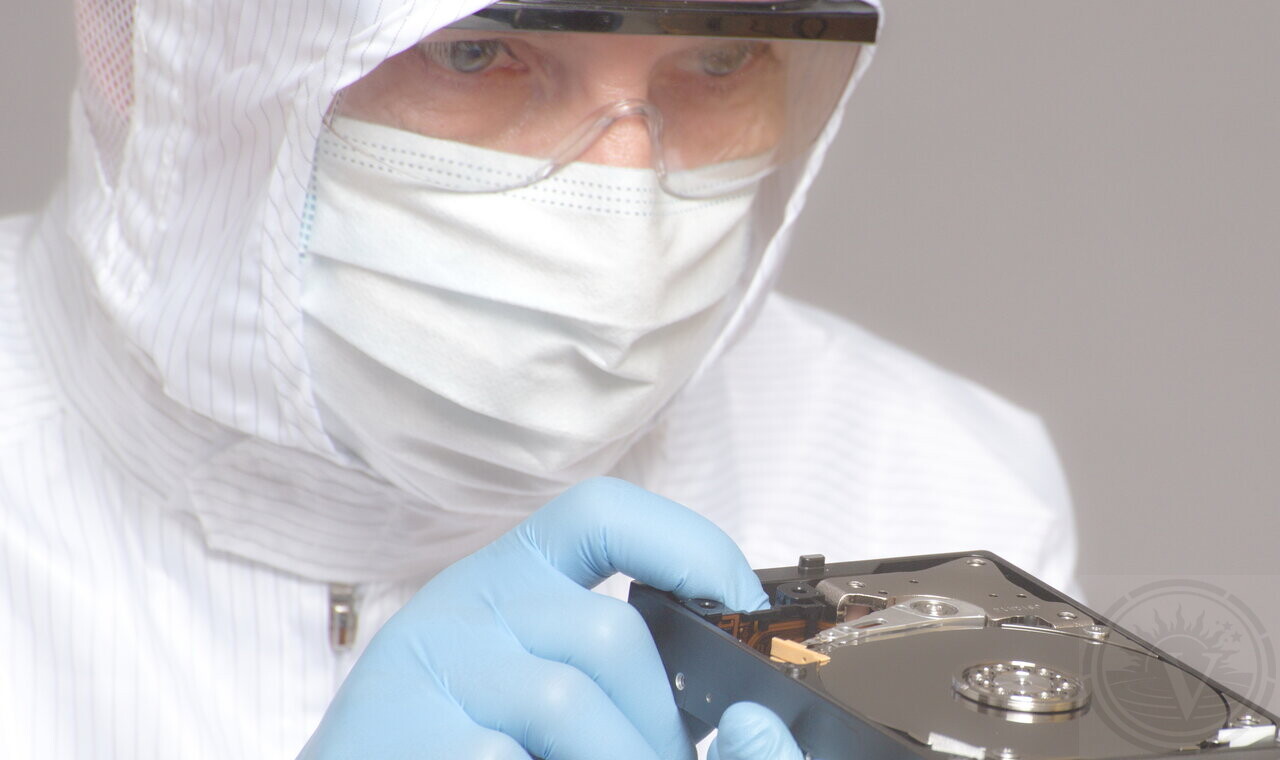 Data recovery specialist handling a hard drive in our laboratory